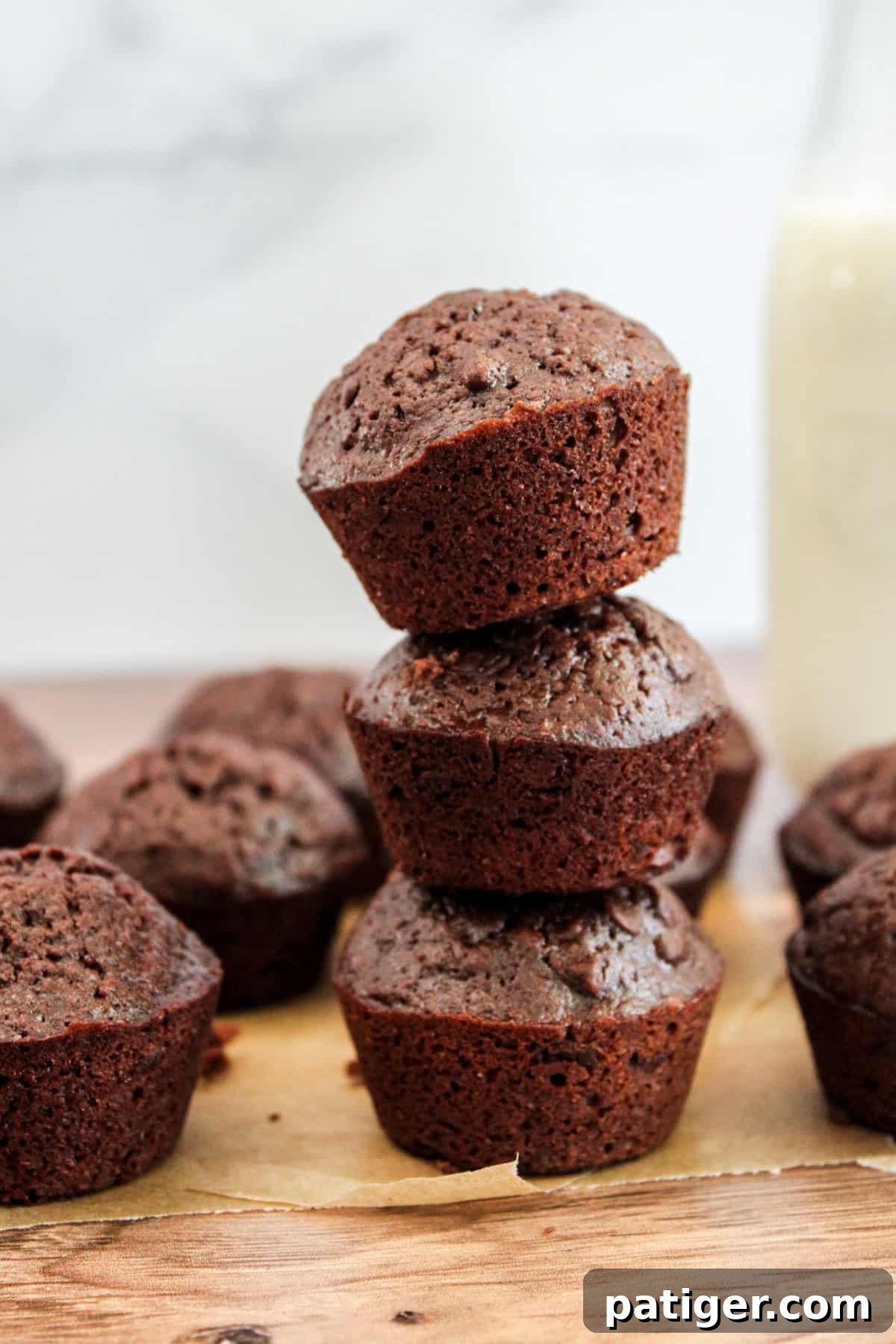 Bite-Sized Brownie Bliss 3 Stack of three mini brownie bites on parchment paper.