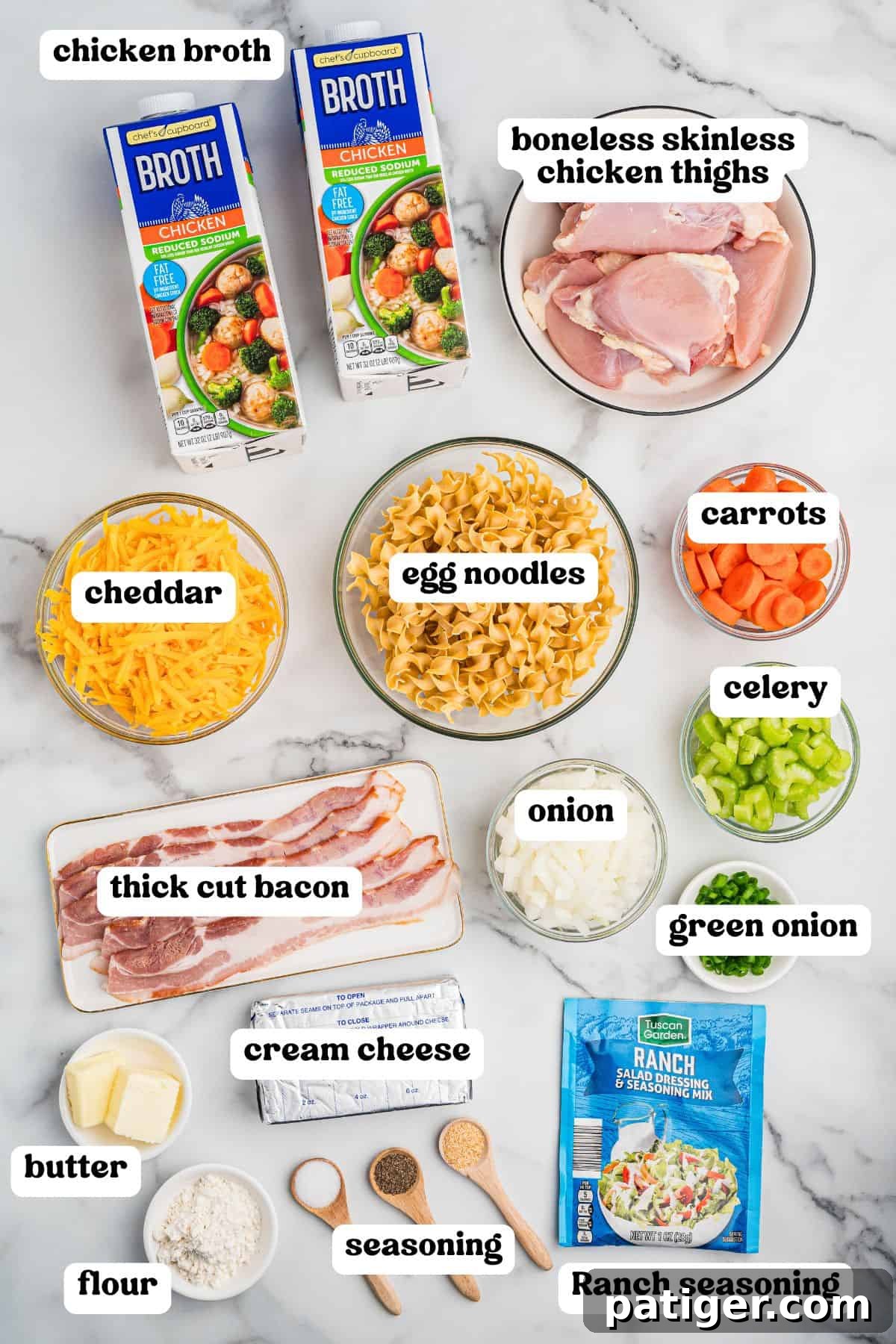 Crack chicken noodle soup ingredients including chicken broth, boneless skinless chicken thighs, egg noodles, cheddar, carrots, celery, green onion, thick cut bacon, onion, butter, flour, cream cheese, various seasonings, and a packet of Ranch seasoning.