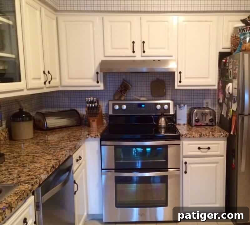 A beautifully updated kitchen featuring newly installed faux granite countertop film, complementing the stainless steel appliances and creating a modern aesthetic.