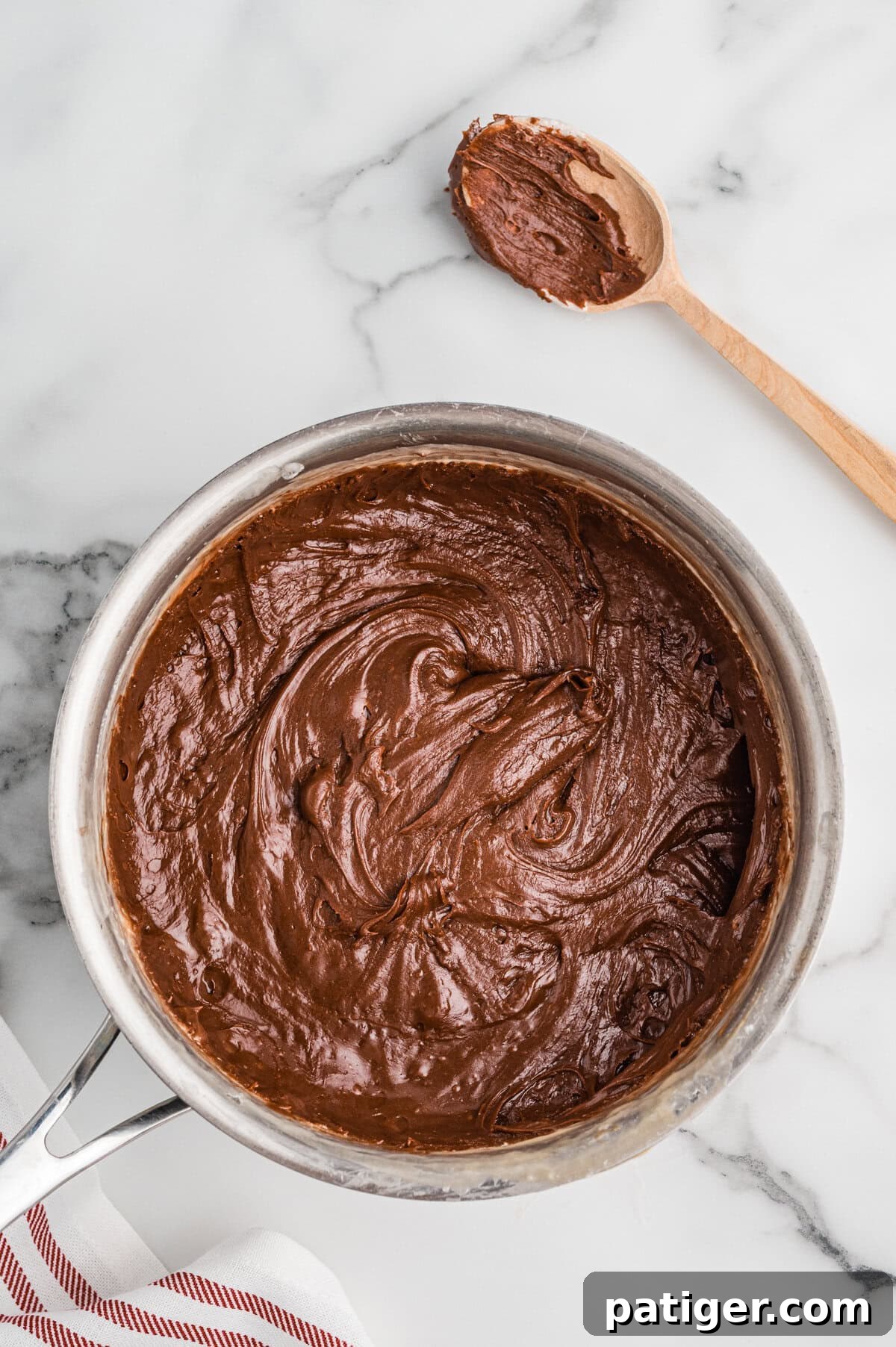 Thick chocolate fudge mixture in a saucepan.