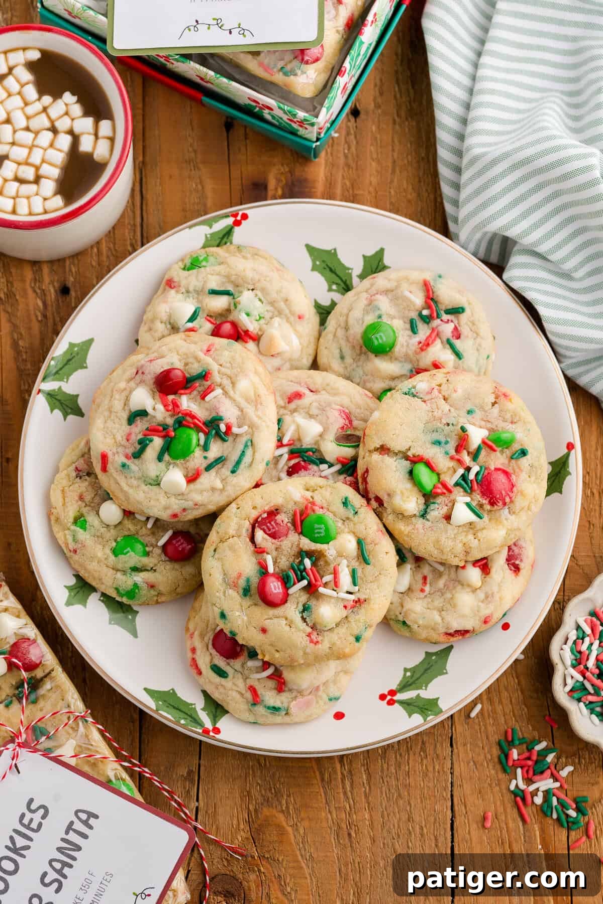 A festive plate of soft, chewy Christmas M&M cookies with white chocolate chips and colorful sprinkles, surrounded by holiday decorations.
