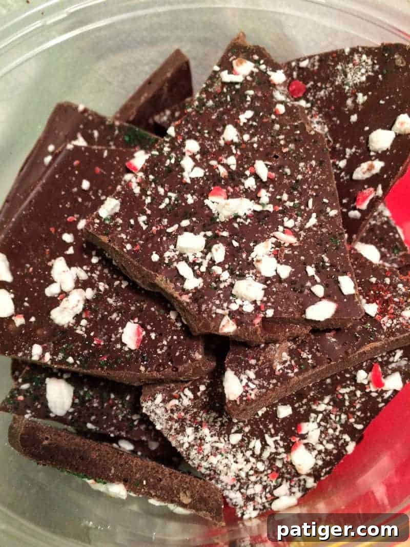 Holiday Peppermint Bark Treat 3 Close-up of Christmas peppermint bark topped with crushed candy canes, showcasing the festive texture.