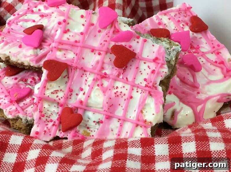 Valentine's Day bark candy made with graham crackers, white and pink melted chocolate, and sprinkles.