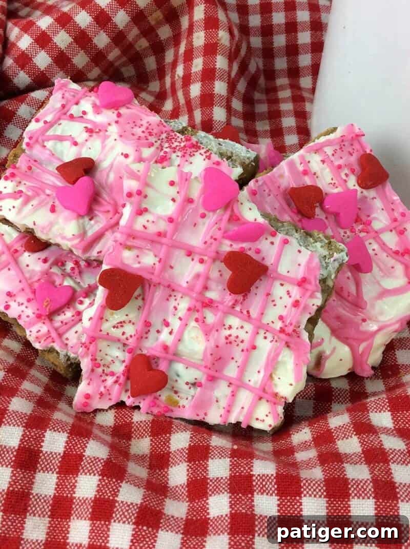 White chocolate graham cracker bark topped with pink chocolate and sprinkles.