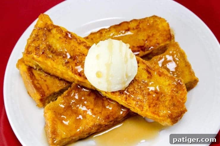 Prepared pumpkin french toast sticks served with butter and maple syrup.