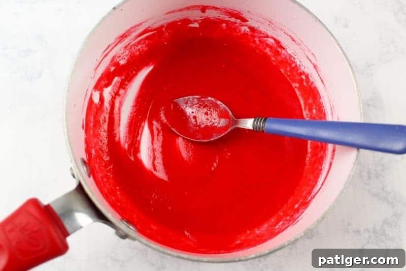 Red melted chocolate in pot.