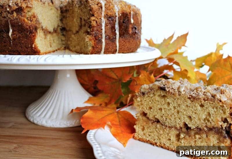 Decadent Maple Walnut Coffee Cake with a generous streusel topping and maple icing drizzle.