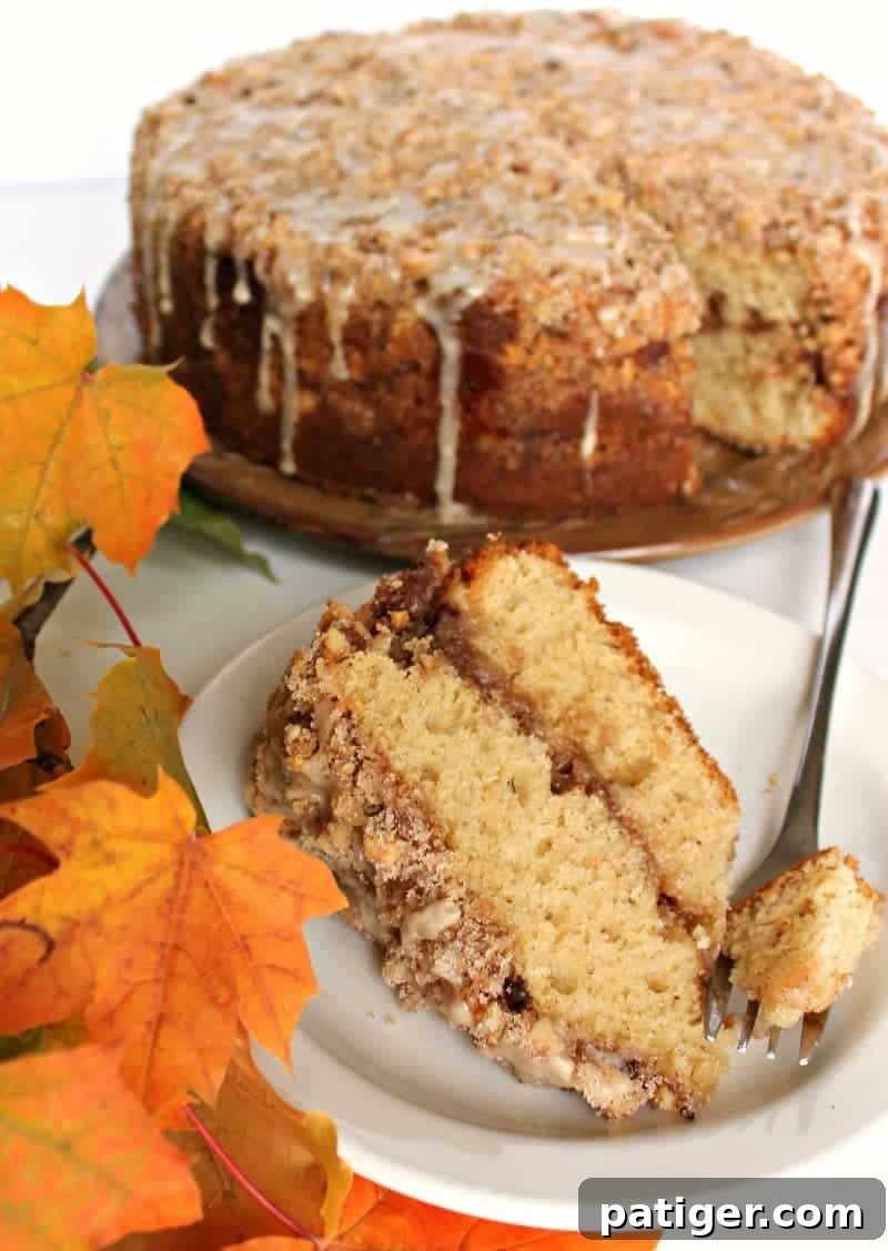 A slice of Maple Walnut Coffee Cake revealing the creamy filling and tender crumb.