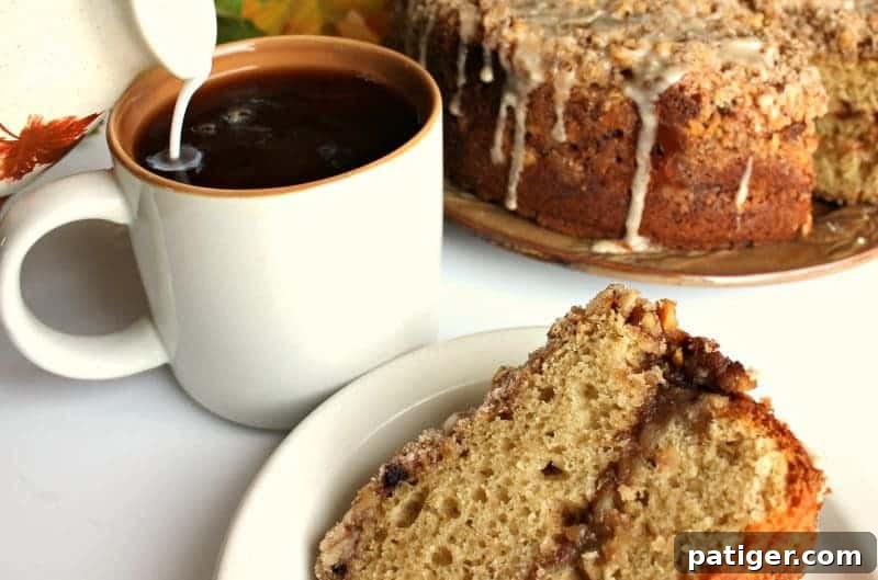Warm Maple Walnut Coffee Cake cooling on a wire rack, steam gently rising.