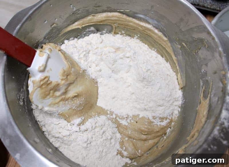 Half of the dry ingredients being gently folded into the coffee cake batter.