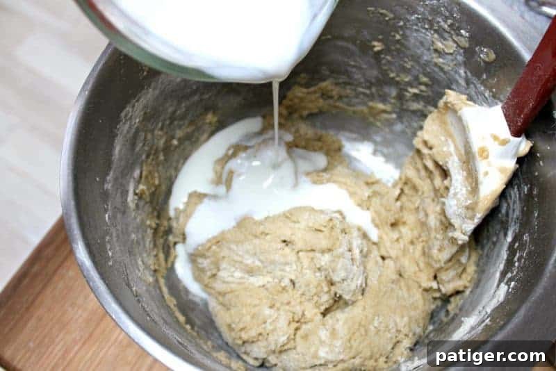Buttermilk being stirred into the coffee cake batter, alternating with dry ingredients.