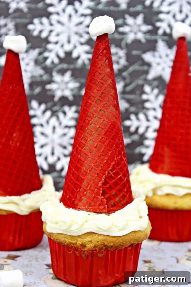 Finished Santa Hat Cupcakes, showcasing the festive red cone and white marshmallow, ready for holiday serving.