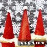 A delicious Santa Hat Cupcake with a red sugar cone and mini marshmallow topper.