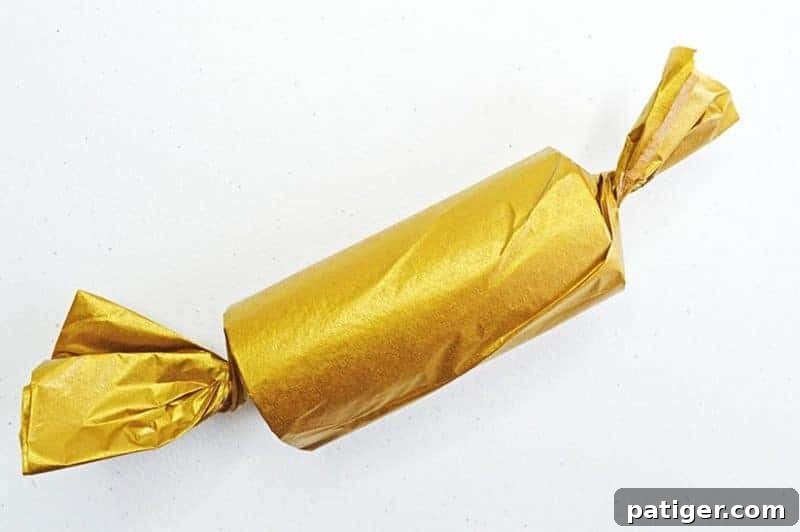 This fun Midnight Kisses New Year's Eve Party Poppers craft is easy to make with toilet paper rolls, tissue paper, ribbon, and the included printable label.