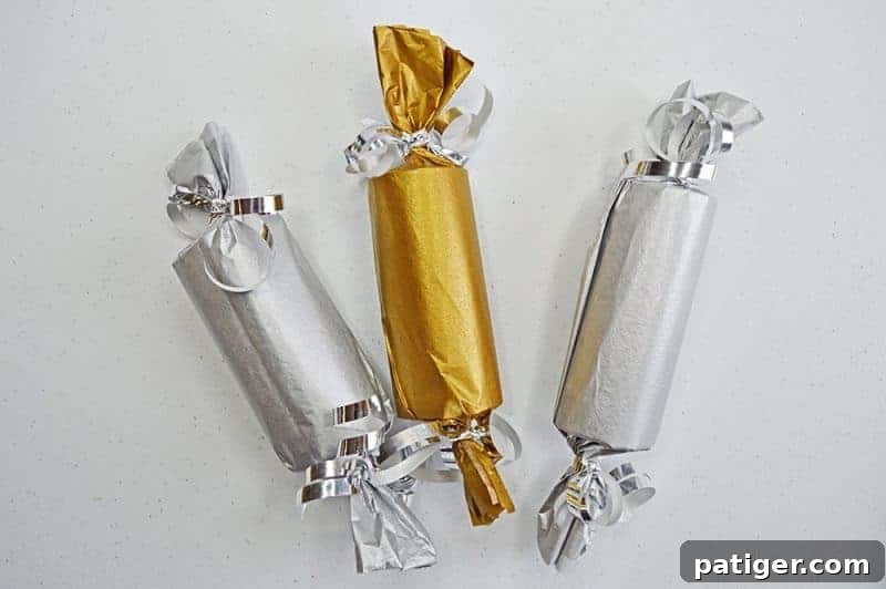 This fun Midnight Kisses New Year's Eve Party Poppers craft is easy to make with toilet paper rolls, tissue paper, ribbon, and the included printable label.