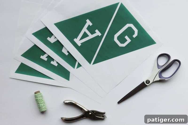 Materials laid out for creating the DIY Game Day banner, including paper, scissors, and string.