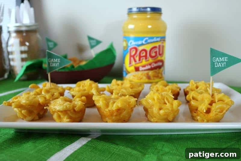 Close-up of golden brown mini mac & cheese cups, a perfect bite-sized appetizer for any football party.