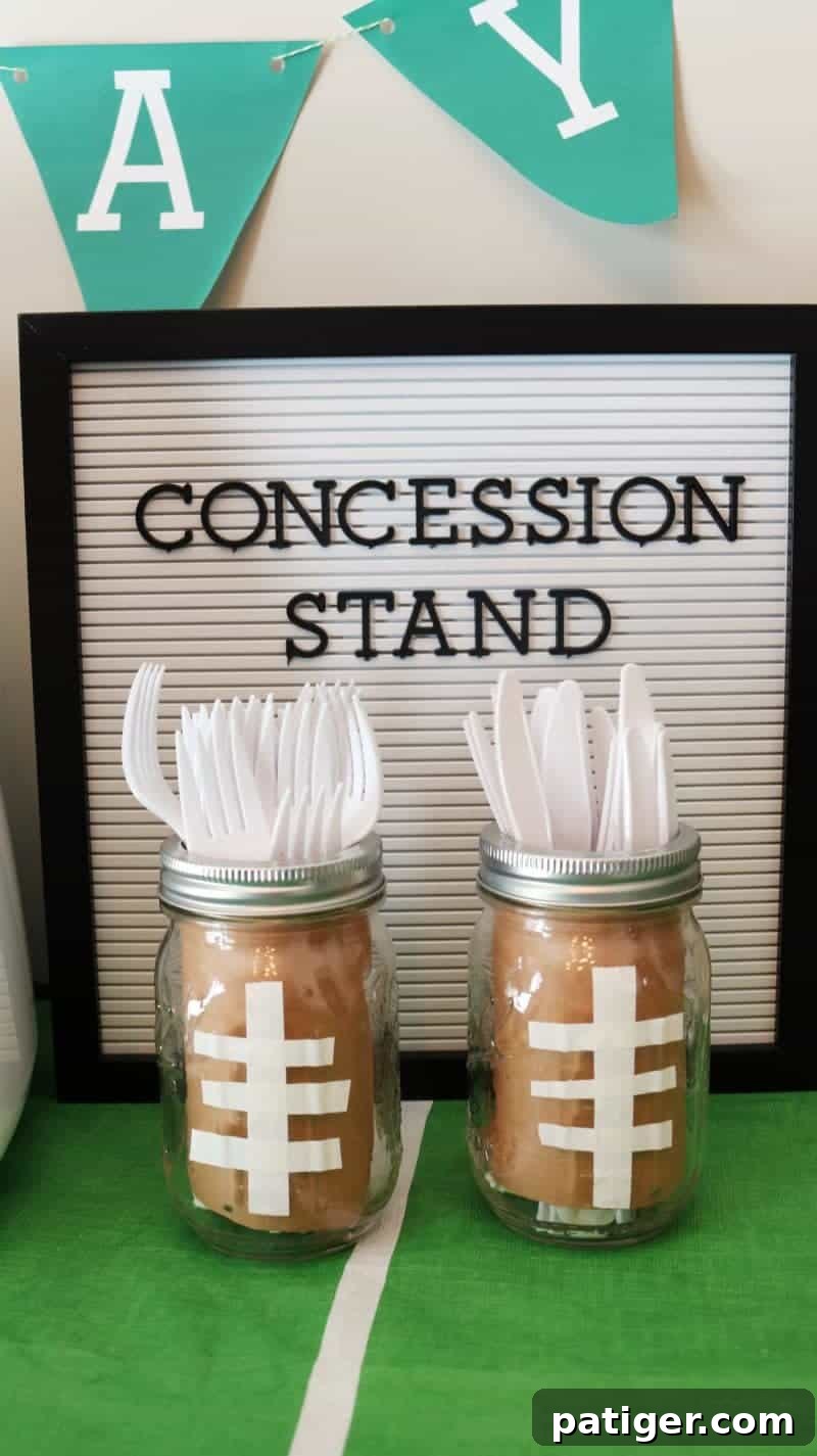 DIY football-themed mason jars, repurposed as utensil holders for a party.