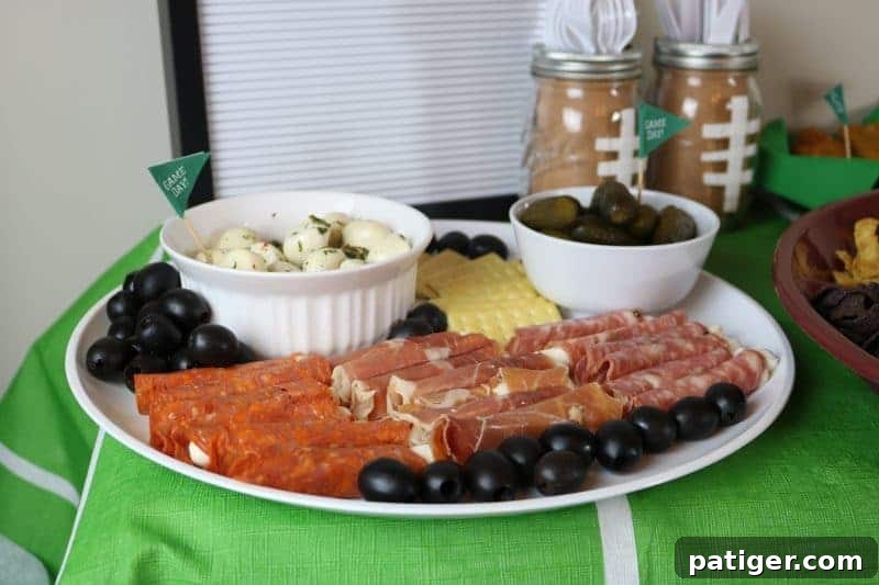 A festive spread of Game Day appetizers, including a charcuterie board, highlighting Formaggio products.