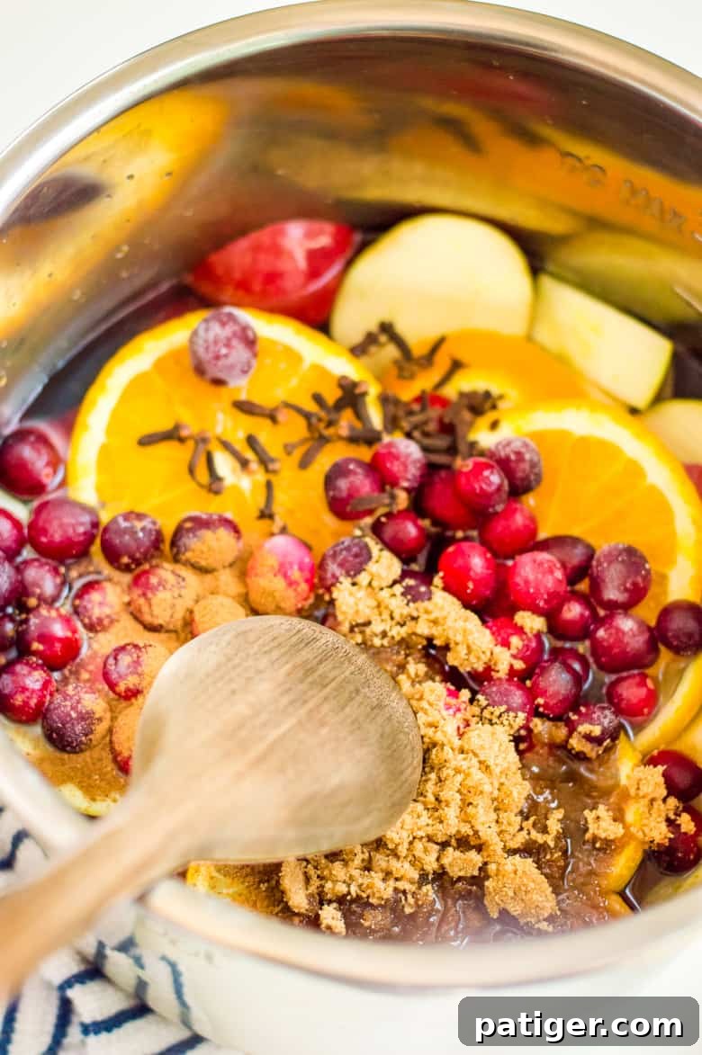 mix together apple cider ingredients in instant pot with wooden spoon