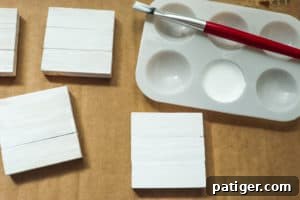 Paint brush, white paint, and painted wood blocks