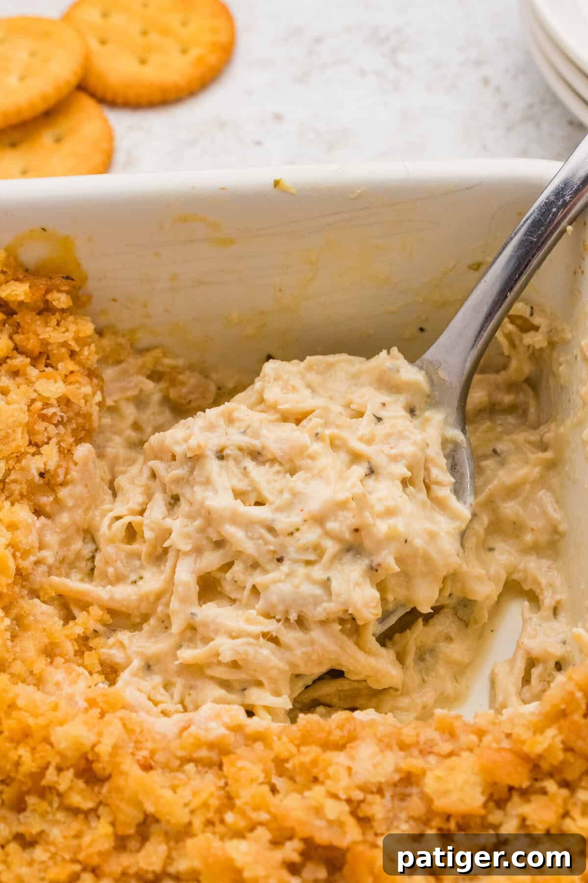 Creamy chicken casserole topped with crushed ritz crackers, ready to be served.
