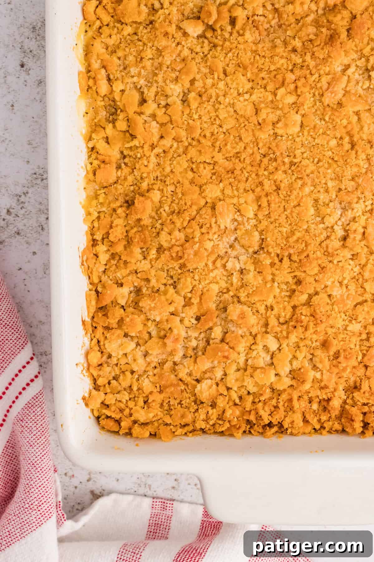 Ritz Cracker Chicken Casserole in white casserole dish, perfectly golden and bubbly.