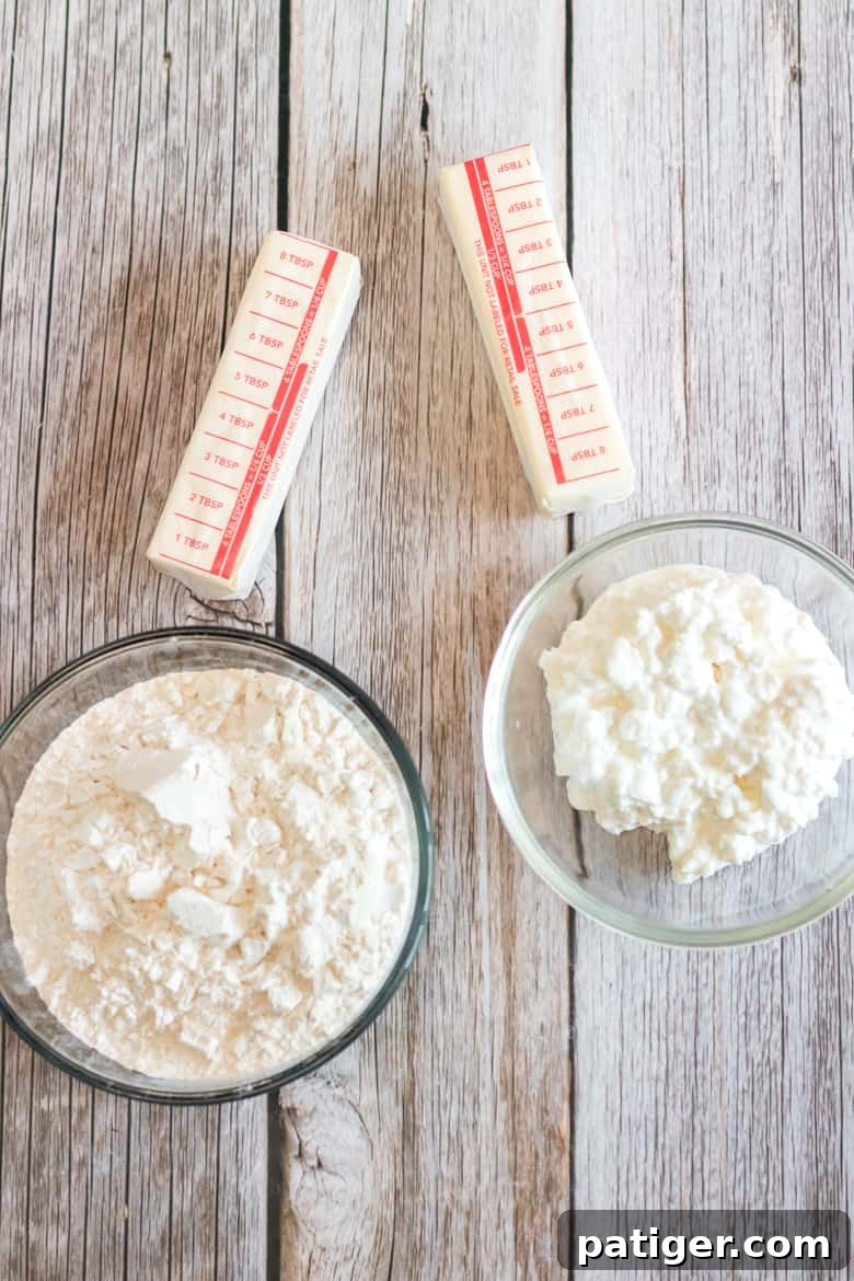 Essential dough ingredients laid out: cubes of cold butter, all-purpose flour, and small curd cottage cheese.