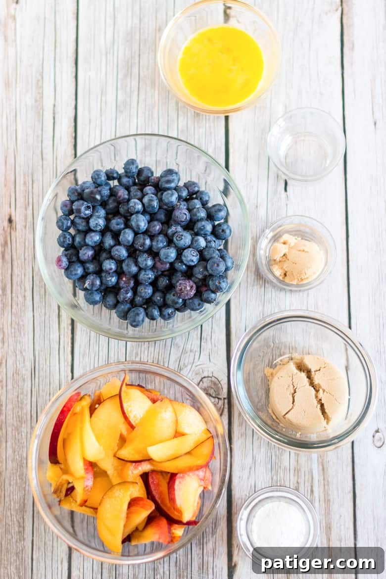 Ingredients for the vibrant peach and blueberry galette filling: sliced peaches, fresh blueberries, brown sugar, cornstarch, and almond extract.