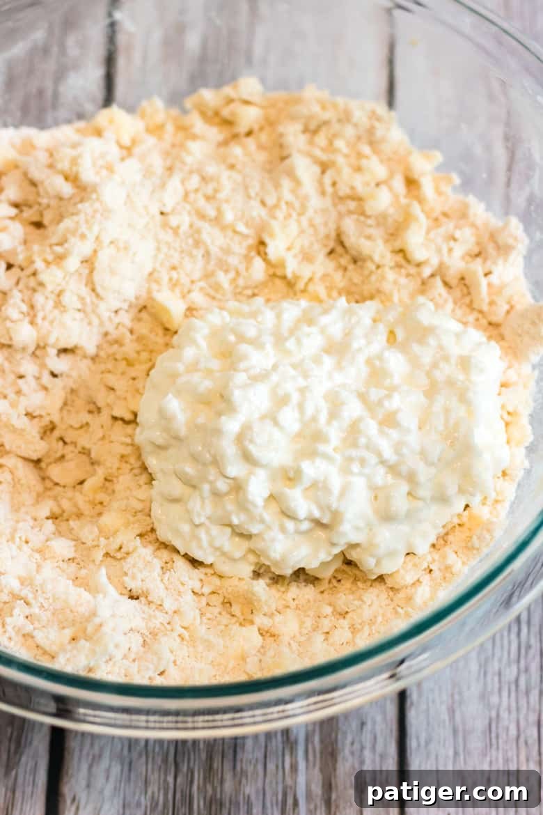 Cottage cheese being mixed into the flour and butter mixture to form galette dough.