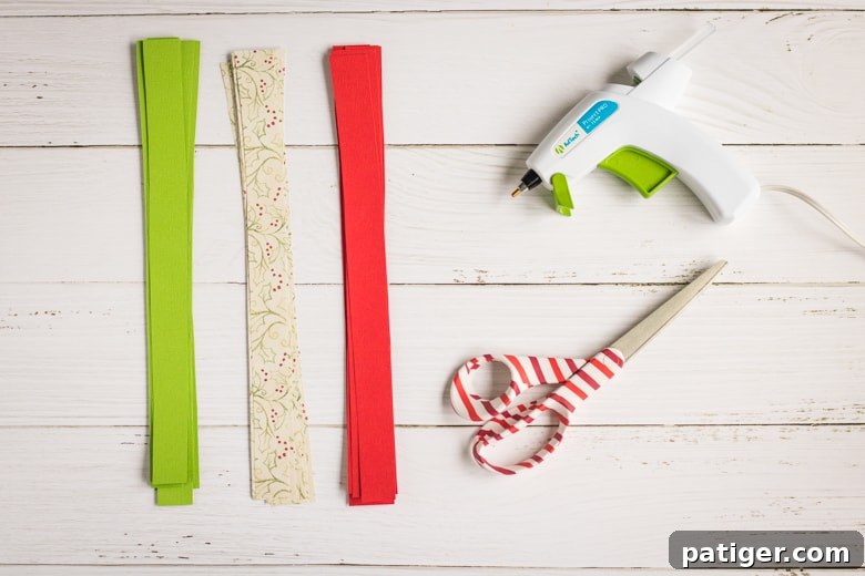 Cut paper into strips: Several sheets of colorful scrapbook paper cut into uniform 1-inch strips, neatly stacked and ready for the next step.