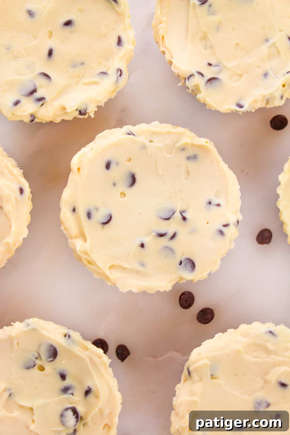 An inviting overhead shot showcasing the perfectly set, individual no-bake cookie dough cheesecake cups, highlighting their rich texture and tempting appearance.
