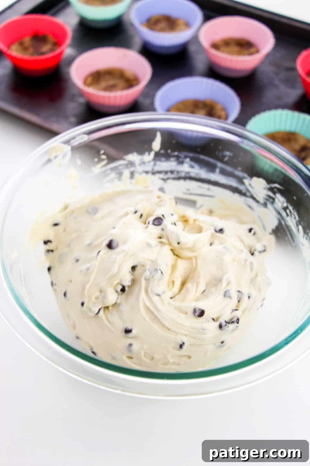 A mixing bowl filled with the creamy, rich no-bake chocolate chip cookie dough cheesecake filling, demonstrating its smooth and ready-to-use consistency.