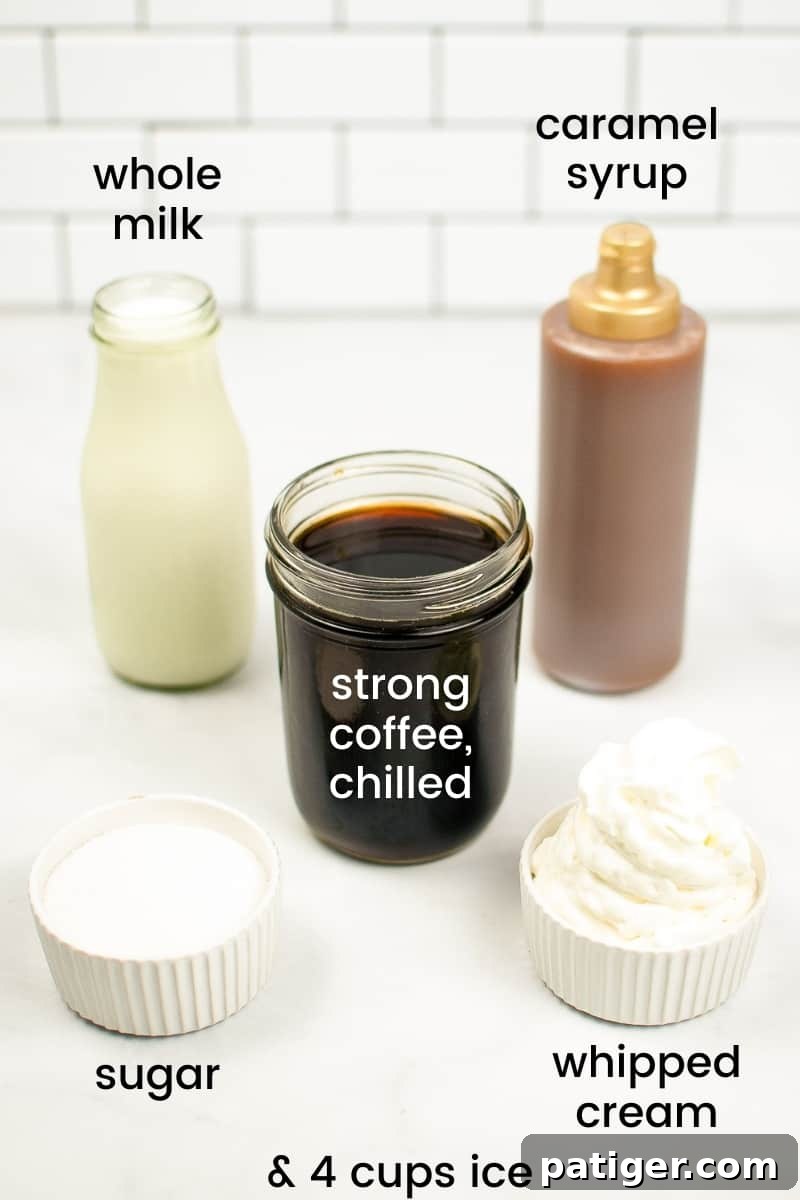glass jar of whole milk, bottle of caramel syrup, jar of chilled strong coffee, bowl of granulated sugar, and bowl of whipped cream