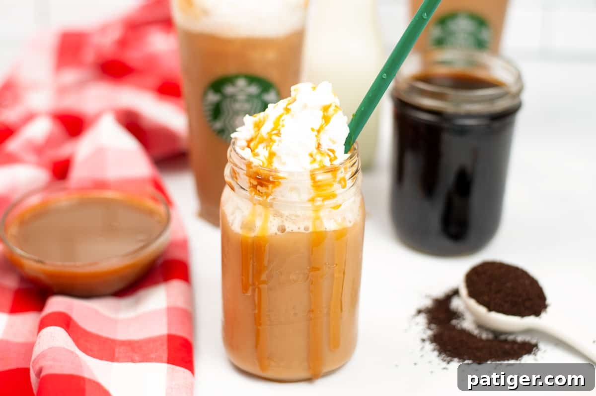 Caramel frappuccino with whipped cream and green straw. Additional cups and a bowl of caramel syrup, cold coffee, and coffee grinds are in background.
