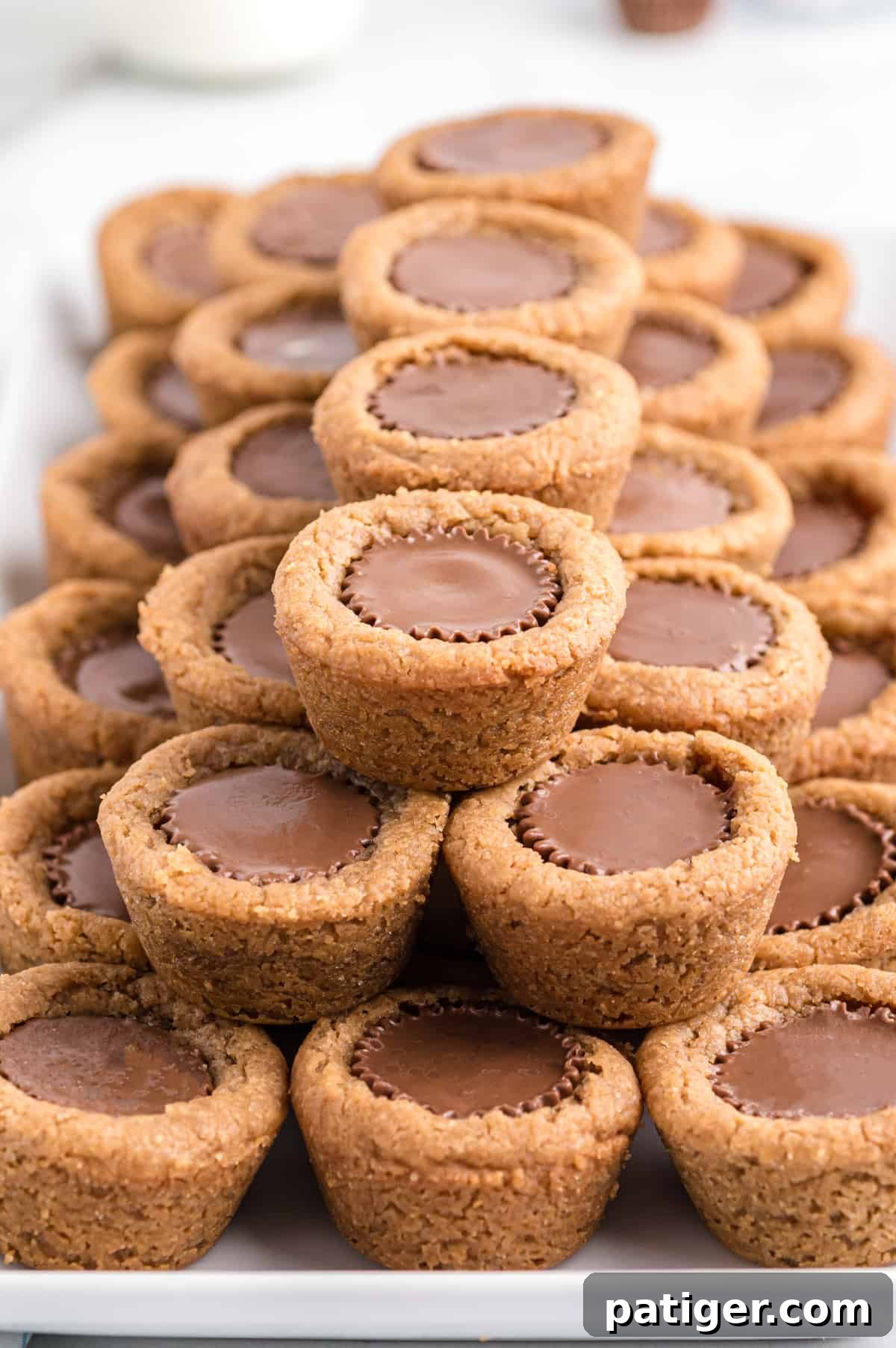 Mini peanut butter cup cookies stacked neatly on serving platter
