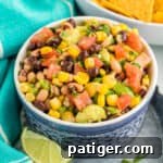 Cowboy Caviar dip with beans, avocado, corn, scallions, and dressing in a bowl, served with tortilla chips