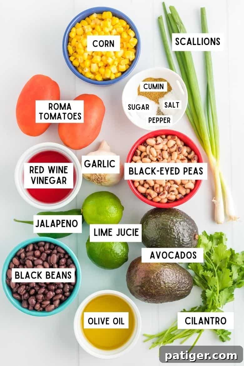 Ingredients on countertop: corn kernels, scallions, roma tomatos, red wine vinegar, black eyes peas, black beans, olive oil, avocados, limes, cilantro, garlic, salt, pepper, sugar, cumin