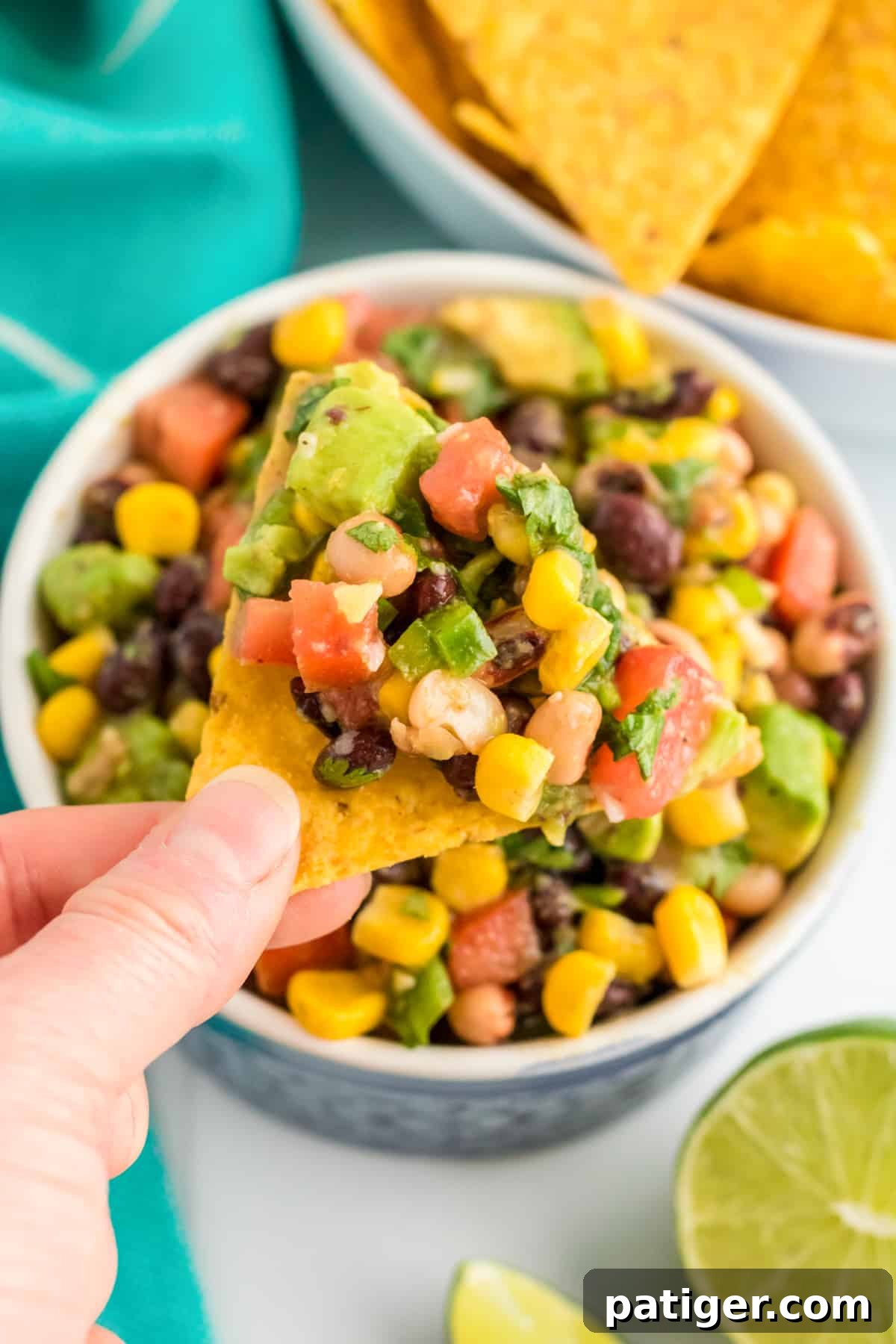 Cowboy Caviar Dip scooped onto tortilla chip