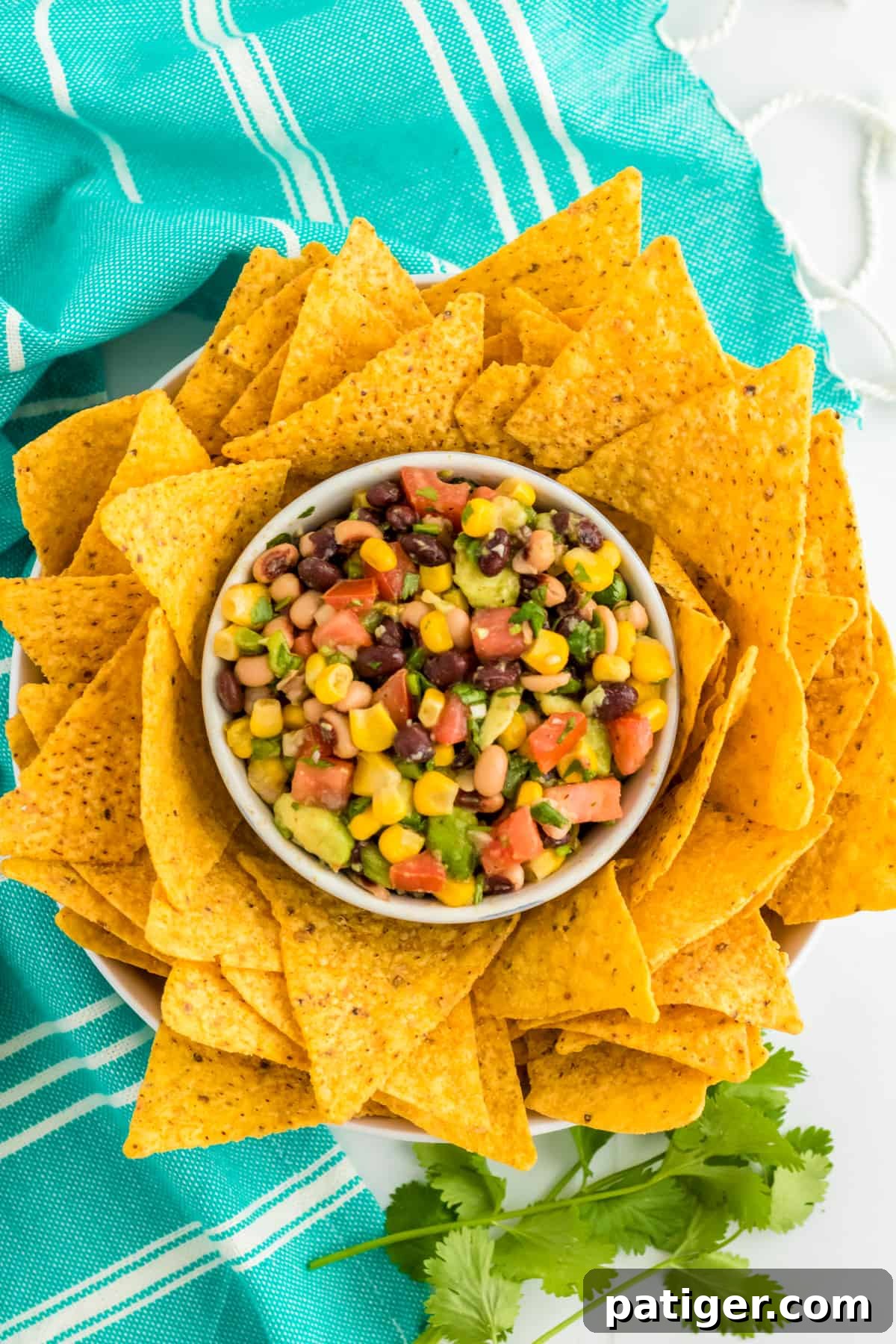 Cowboy Caviar Dip in a bowl surrounded by tortilla chips