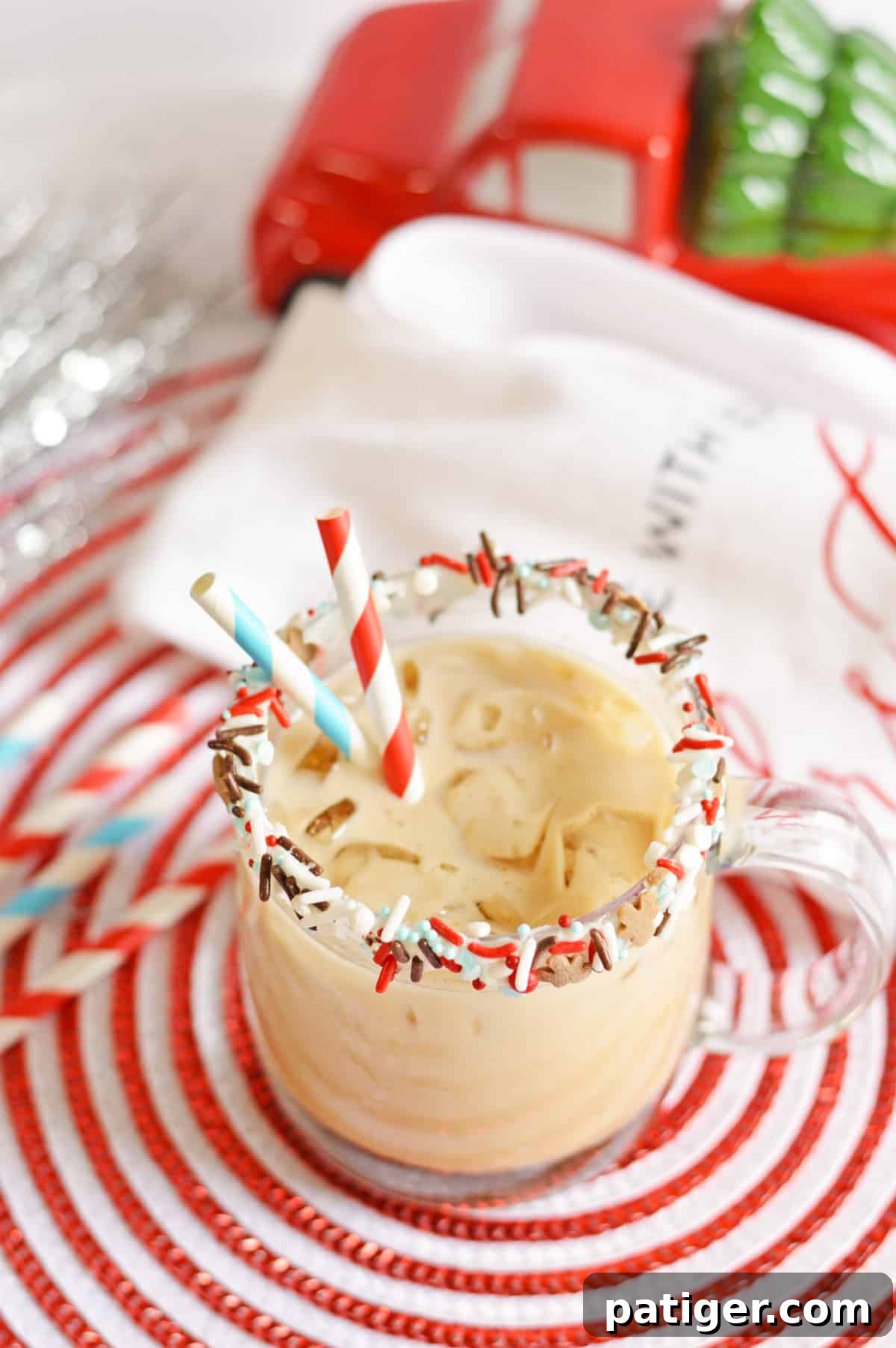 The finished Gingerbread Cookie Cocktail in a glass mug, rimmed with vanilla frosting and sprinkles, ready to be enjoyed.