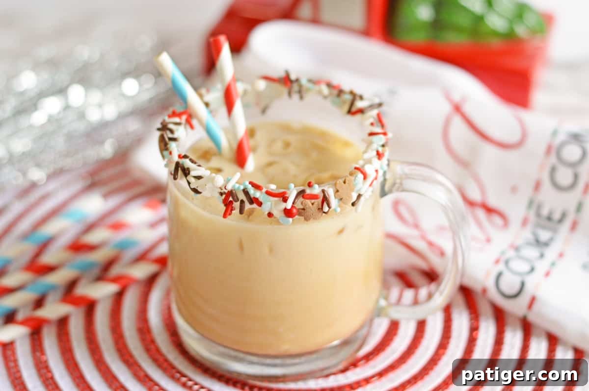 Gingerbread vodka cocktail in a sprinkle-rimmed glass mug with paper straws, surrounded by festive holiday decor in the background.