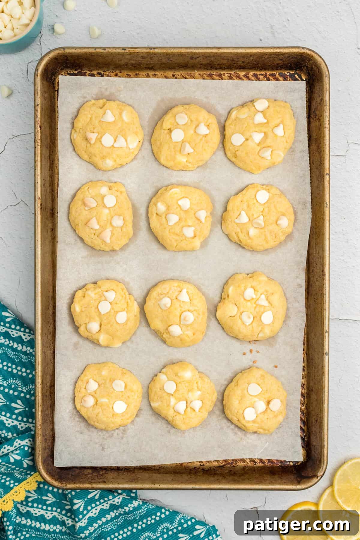 Freshly baked lemon pudding cookies on a cookie sheet.