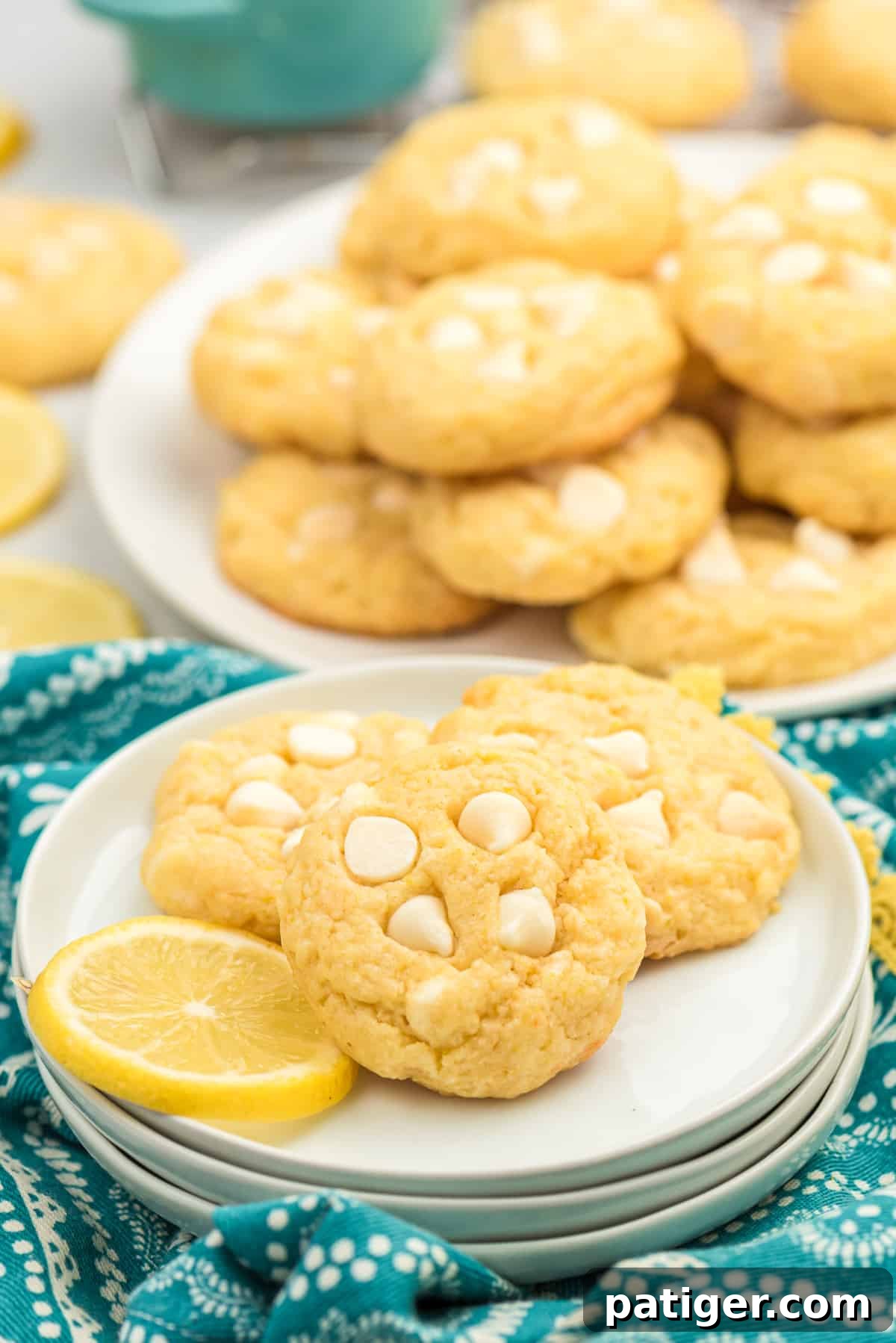 Lemon cookies on a plate with a fresh lemon slice, ready to be enjoyed.