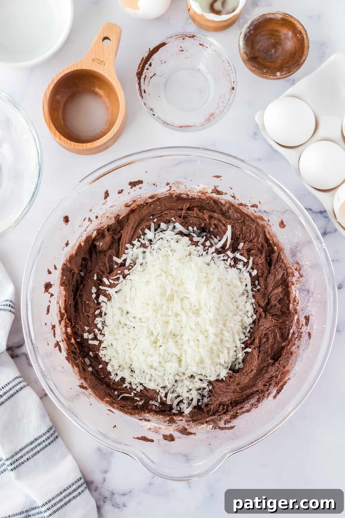 Shredded coconut added to batter in mixing bowl.