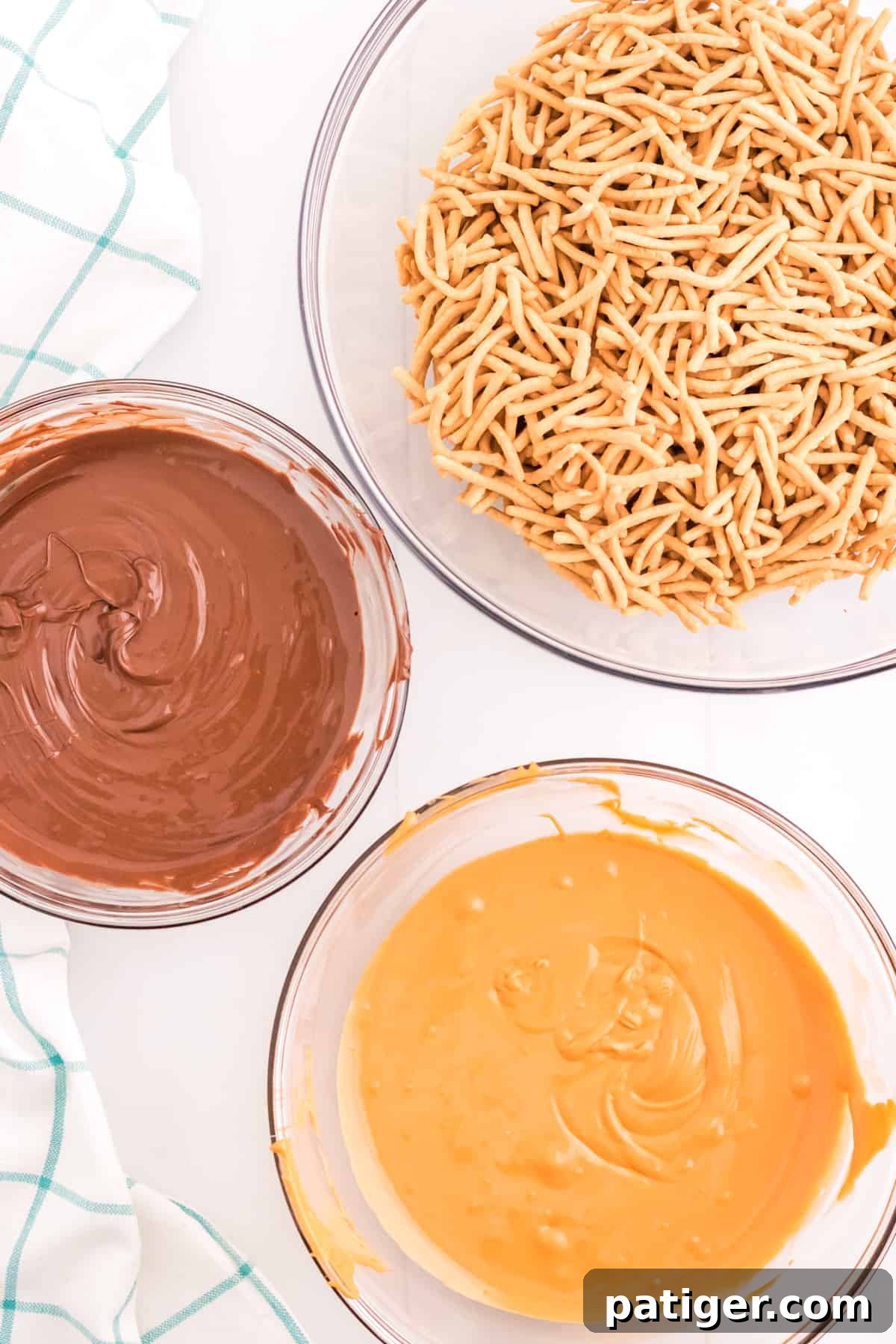 Bowl of melted chocolate, bowl of melted butterscotch, and bowl of chow mein noodles.