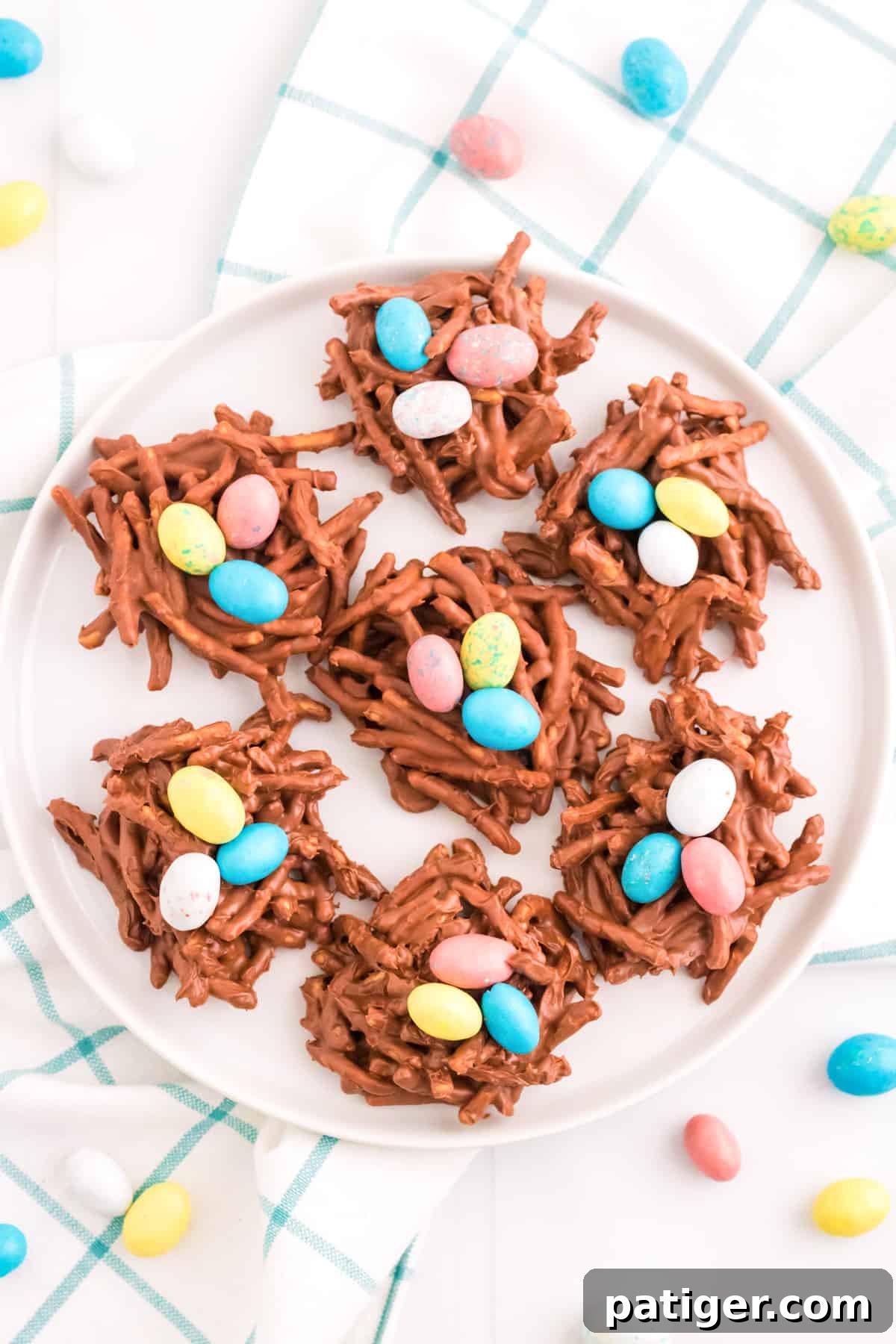 No-bake chocolate birds nest cookies with colorful eggs in the center.
