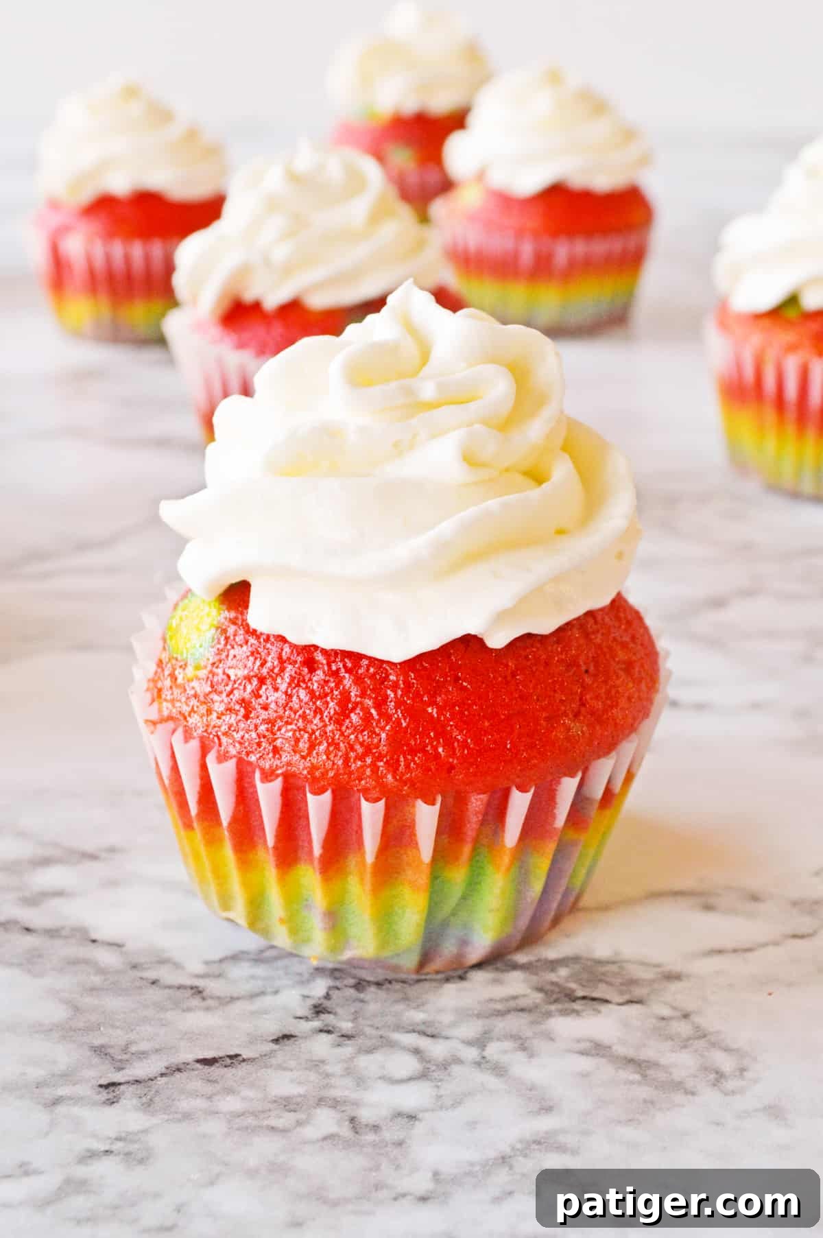 Rainbow cupcake from cake mix topped with vanilla frosting.