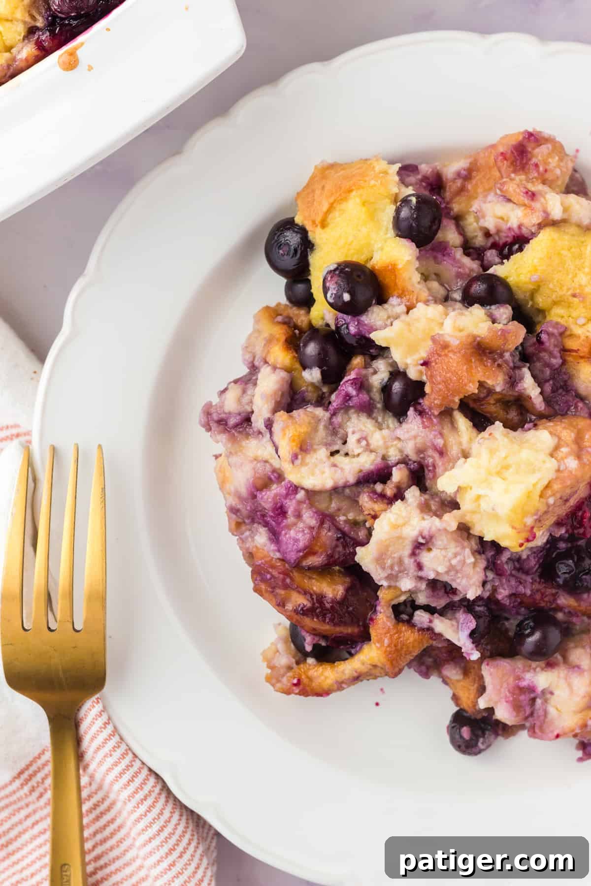 Blueberry lemon bread pudding scooped onto a plate.