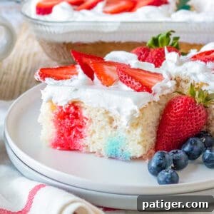 Red, white, blue 4th of july poke cake with fresh berries.